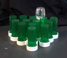 a group of green plastic cups sitting on top of each other