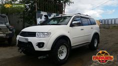 a white suv parked in front of a building