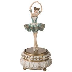 a figurine with a ballerina on it's head and arms in the air