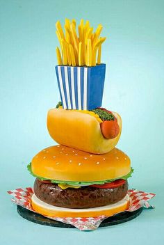 a hamburger with fries and a hot dog on it