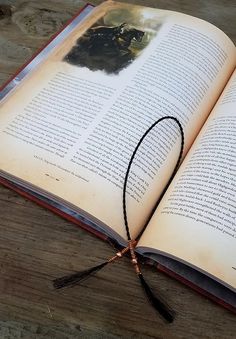 an open book sitting on top of a wooden table