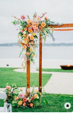 an outdoor ceremony setup with flowers and greenery