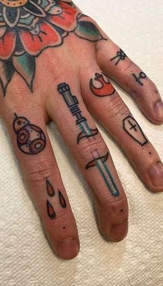 a person's hand with tattoos on it