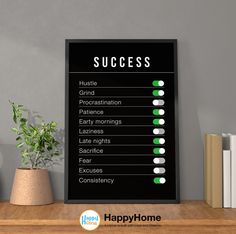 a black and white sign that says success on it next to a potted plant