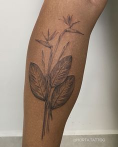 a tattoo on the leg of a woman with flowers