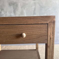 a close up of a wooden table with a drawer on the bottom and one drawer open