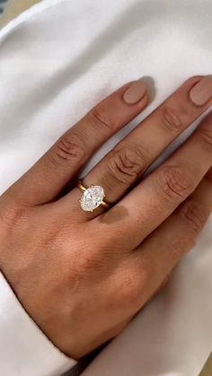 a woman's hand with a diamond ring on it