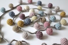 several crocheted balls are on a string