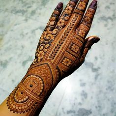 a woman's hand is decorated with hennap and intricate designs on it