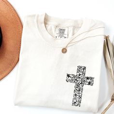 This elegant Floral Cross T-Shirt for women beautifully combines faith and nature. Featuring a delicate flower cross design, it's perfect for expressing your Christian beliefs with grace and style. Whether for daily wear or as a thoughtful gift, this inspirational faith-based tee adds a feminine touch to your spiritual journey. Ideal for women who want to wear their faith proudly! The Fit * True to Size: Enjoy a relaxed fit that stays true to size. * Versatile Sizing: For an oversized fit, simpl Cross Christian, Flower Cross, Floral Cross, Christian Sweatshirt, Christian T Shirt, Pompano Beach, Cross Design, Cross Designs, T Shirt For Women