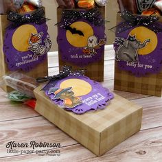 three halloween treat bags sitting on top of a table