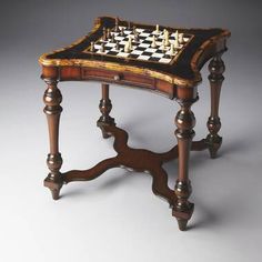 an old wooden chess board table with two pieces on it's legs and one piece in the middle