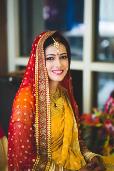 a woman in yellow and red outfit sitting down