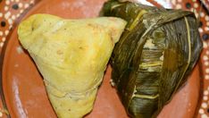 there are two pieces of artichoke on the plate, one is wrapped in banana leaf