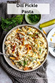 a bowl filled with pasta and vegetables on top of a gray towel next to a fork