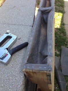 a hammer is laying on the ground next to a piece of wood