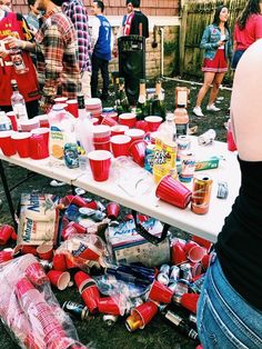 people standing around a table full of food and drinks