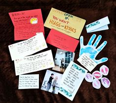 several pieces of paper with handprints and other items on top of a brown blanket