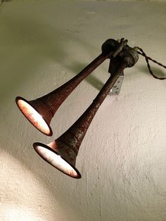 two old fashioned light fixtures hanging from a wall