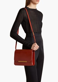 A flap-front handbag in beautifully structured calfskin. Engraved closure and internal slip pocket. Remove the adjustable strap to carry by hand. Luxury Cognac Rectangular Flap Bag, Classic Cognac Flap Bag With Gold-tone Hardware, Chic Cognac Shoulder Bag With Turn-lock Closure, Luxury Cognac Leather-lined Bag, Cognac Rectangular Bag With Turn-lock Closure, Cognac, Calf Skin, Carry On, Adjustable Straps