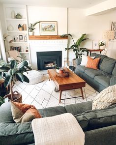 a living room filled with furniture and a fire place in the middle of the room