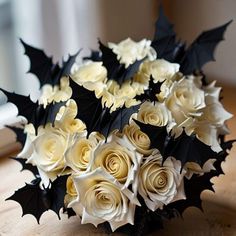 a bouquet of white and black flowers on a table