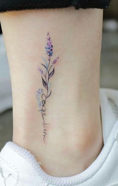 a small flower tattoo on the ankle