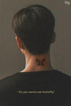 the back of a woman's neck with a butterfly tattoo on her left side