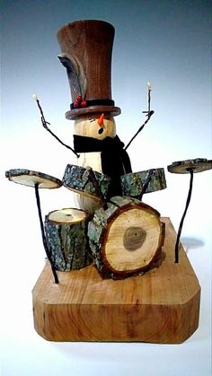 a snowman made out of wood with drums