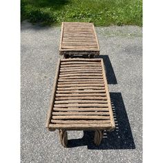 a wooden bench sitting on top of a cement ground