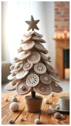 a small crocheted christmas tree with buttons on the top and star decorations around it