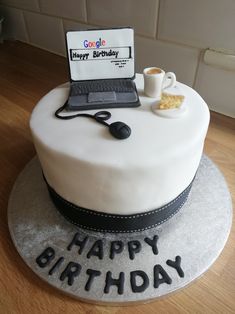 a birthday cake with a laptop on it and a cup of coffee next to it