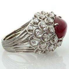 For Sale on 1stdibs - This captivating ring from David Webb features an open-design dome crown prong-set with an oval 11.0mm x 15.0mm cabochon ruby and surrounded by 36 sparkling Luxury Ruby And Diamond Oval Cabochon Ring, Luxury Ruby Ring With Oval Cabochon Diamond, Luxury Ruby Cabochon Diamond Ring, Luxury Oval Cabochon Ruby Ring, Luxury Ruby Ring With Oval Cabochon, Oval Cabochon Ruby Ring With Diamonds, Formal Ruby Ring With Diamond And Oval Cabochon Shape, Formal Oval Cabochon Ruby Ring With Diamond, Fine Jewelry Ruby Cabochon Ring In White Gold