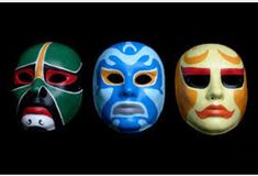 three masks with faces painted on them in different colors