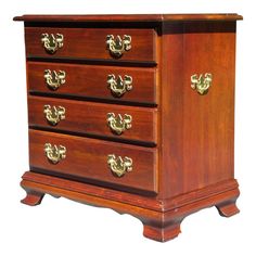 an old wooden dresser with brass handles on it's sides and two drawers in the middle