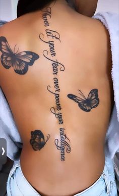 the back of a woman's body with butterflies on it and words written in cursive writing