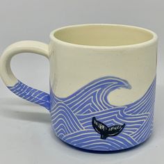 a blue and white mug with a whale on it