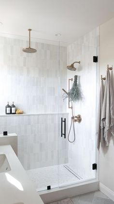 a bathroom with a walk in shower next to a sink