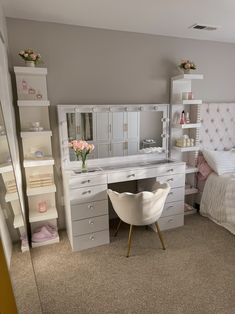 a bedroom with a bed, desk and mirror on the wall next to each other