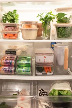 an open refrigerator filled with lots of vegetables and food in containers on top of the shelves