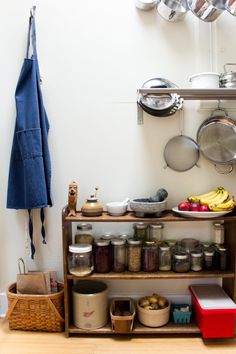 a kitchen with pots, pans and other cooking utensils hanging on the wall