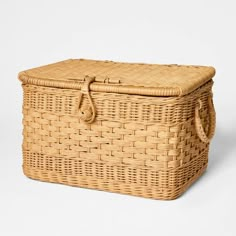 an empty wicker basket with handles on a white background for use as a storage container