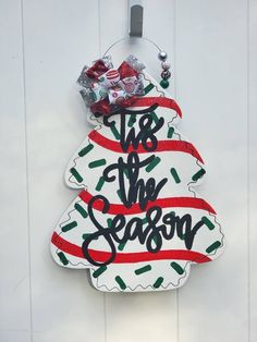 a christmas ornament hanging on the side of a door with candy in it