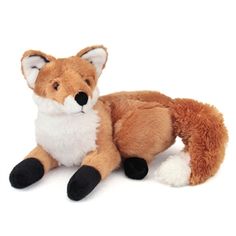 a stuffed fox is laying down on the ground