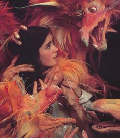 a woman is surrounded by monster like creatures