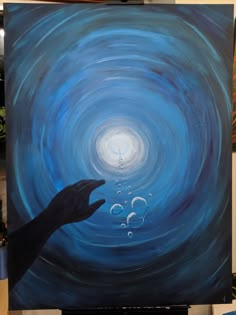 a painting of a hand reaching for bubbles in the water