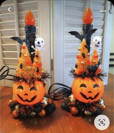 two decorated pumpkins sitting on top of a wooden table