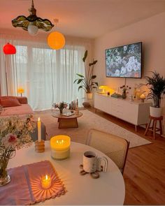 a living room filled with furniture and a flat screen tv mounted to the side of a wall