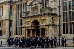 a group of people standing in front of a building