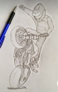 a drawing of a person riding a motorcycle on paper with a pen next to it